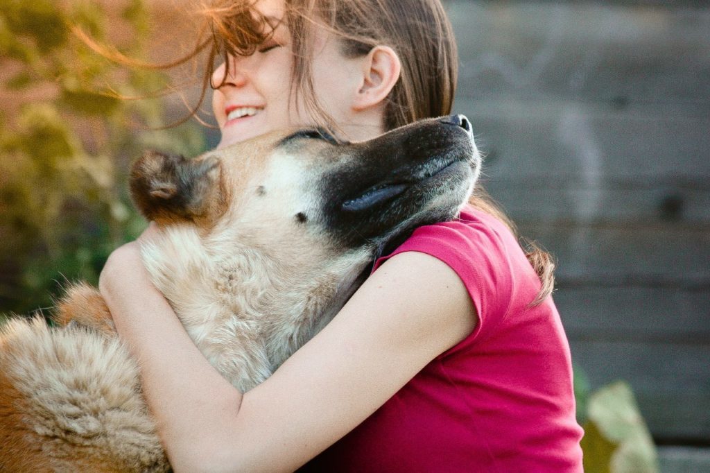 dog and girl hugging